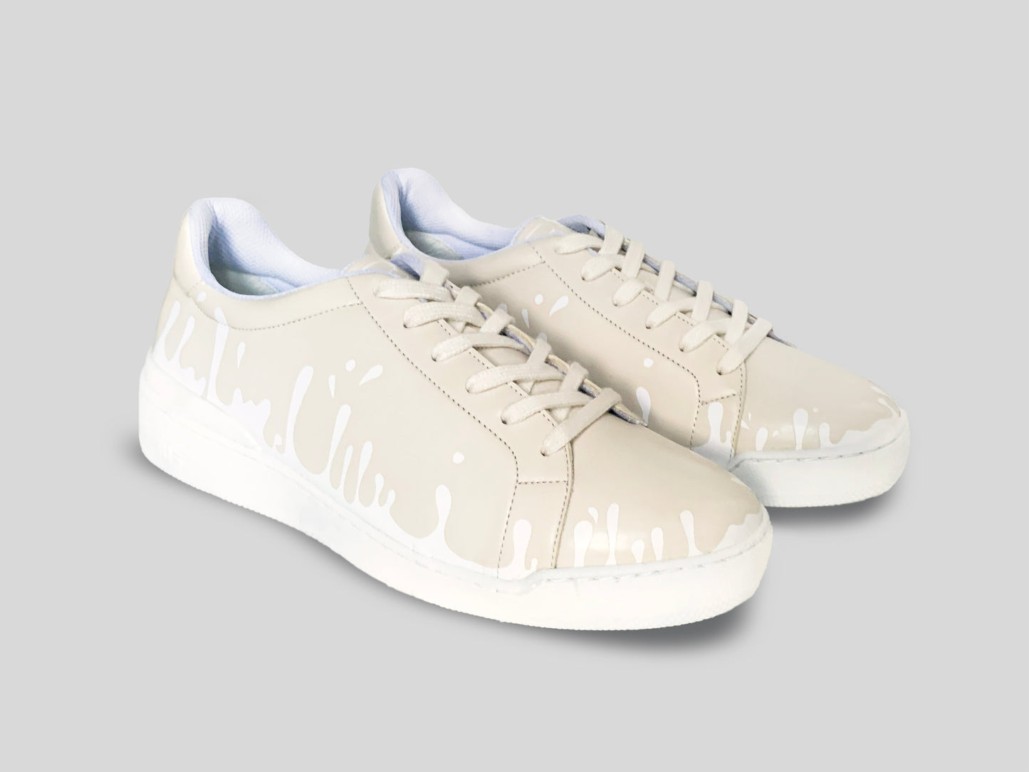 Pair of cream Chrome-Free Nappa leather low-top sneakers with exclusive printed white drops design and white soles