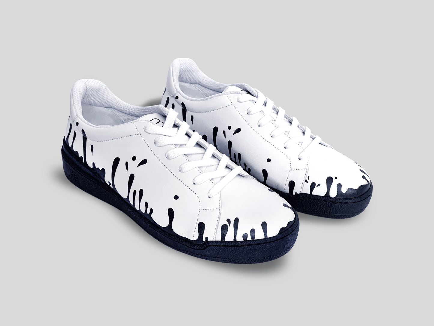 Pair of white Nappa leather low-top sneakers with exclusive printed black drops design and black soles
