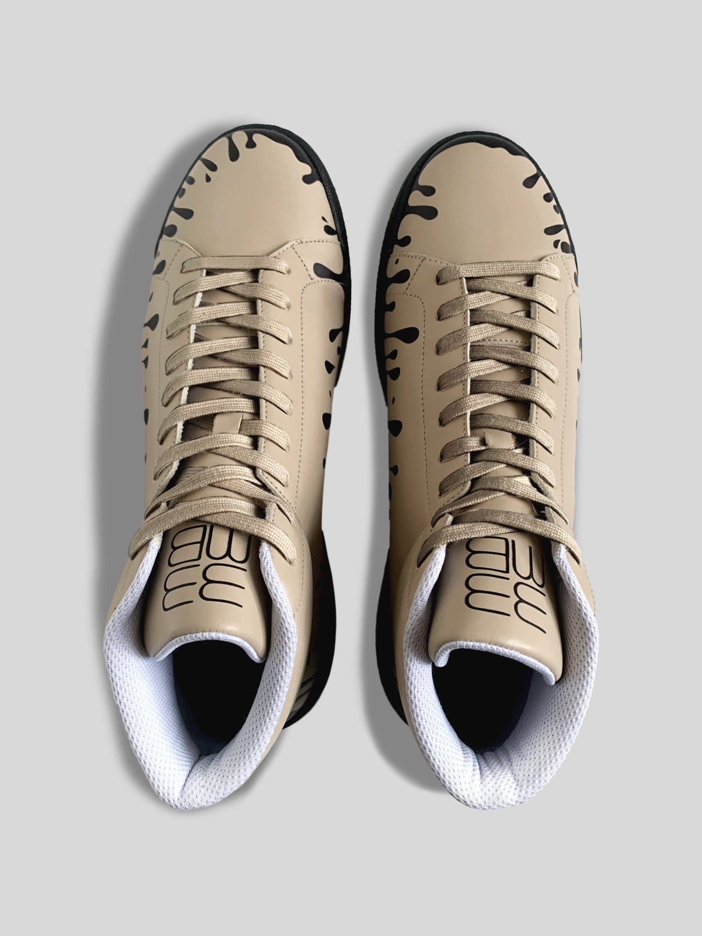 Upper view of pair of beige Nappa leather mid-top sneakers with exclusive printed black drops design