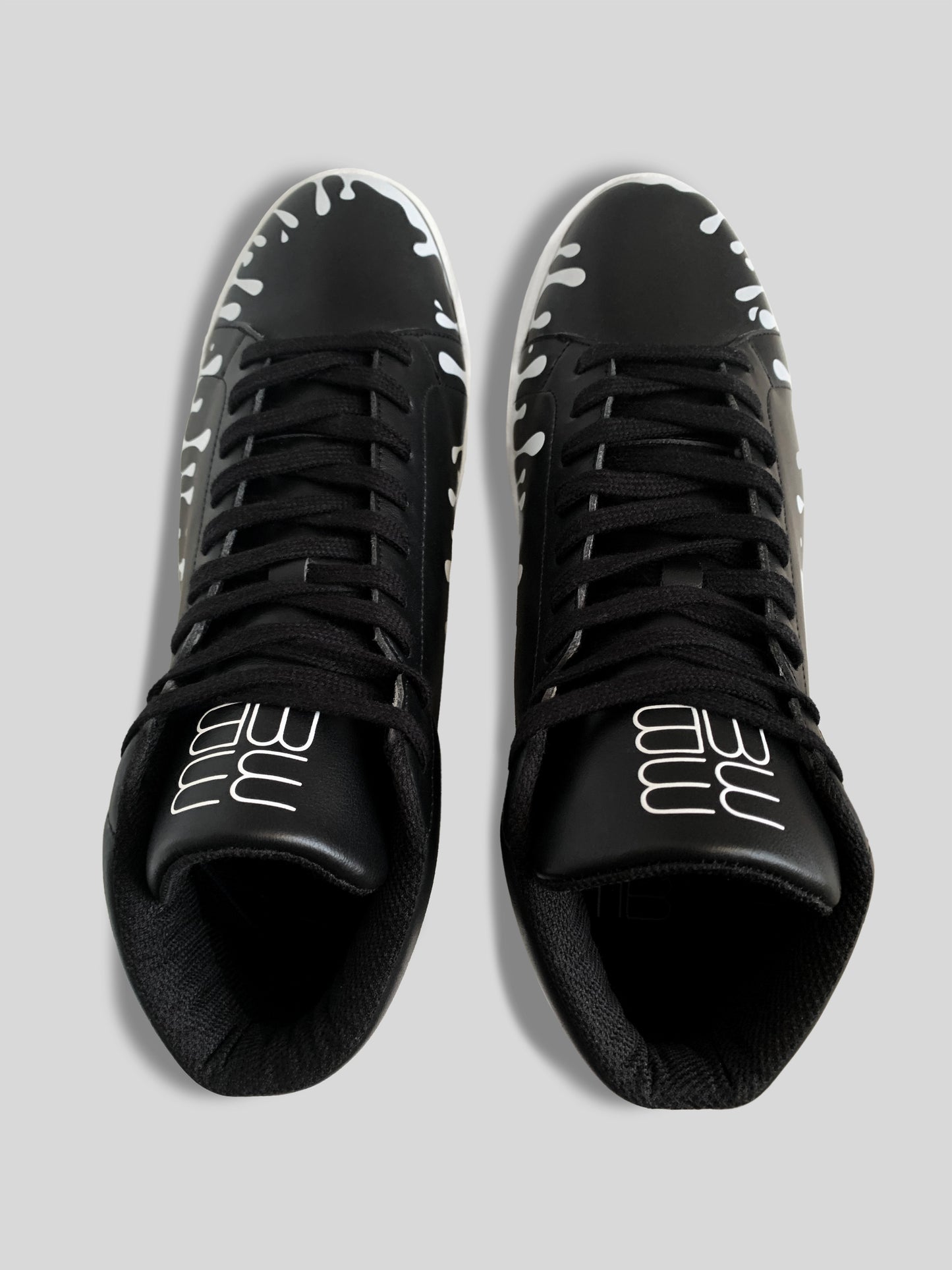 Top view of pair of black Nappa leather mid-top sneakers with exclusive printed white drops design