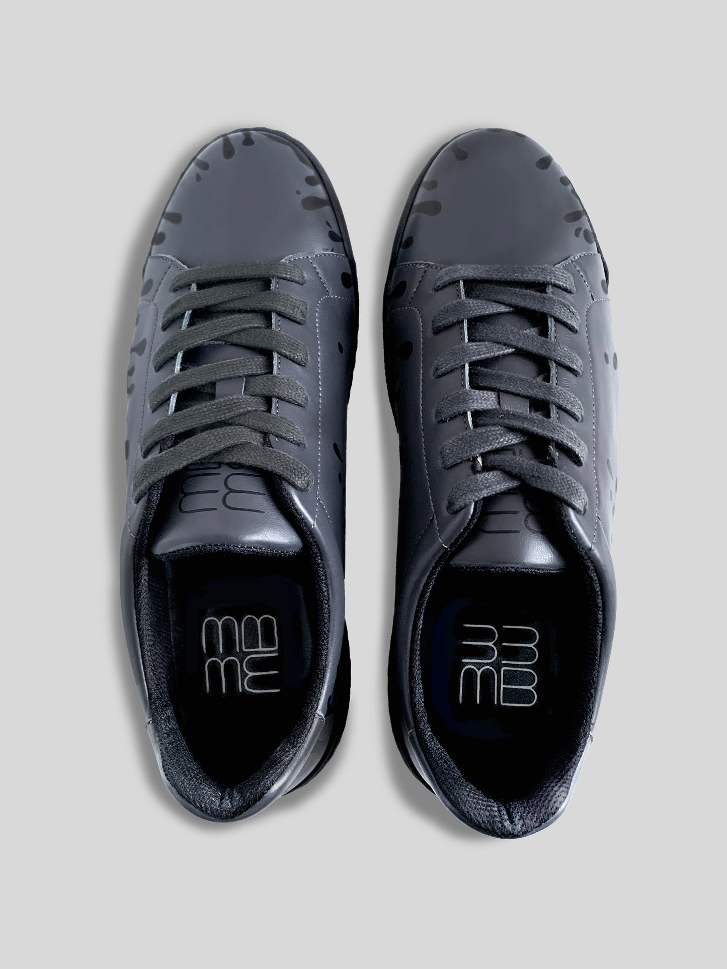 Top view of pair of dark grey Chrome-free Nappa leather low-top sneakers with exclusive printed black drops design