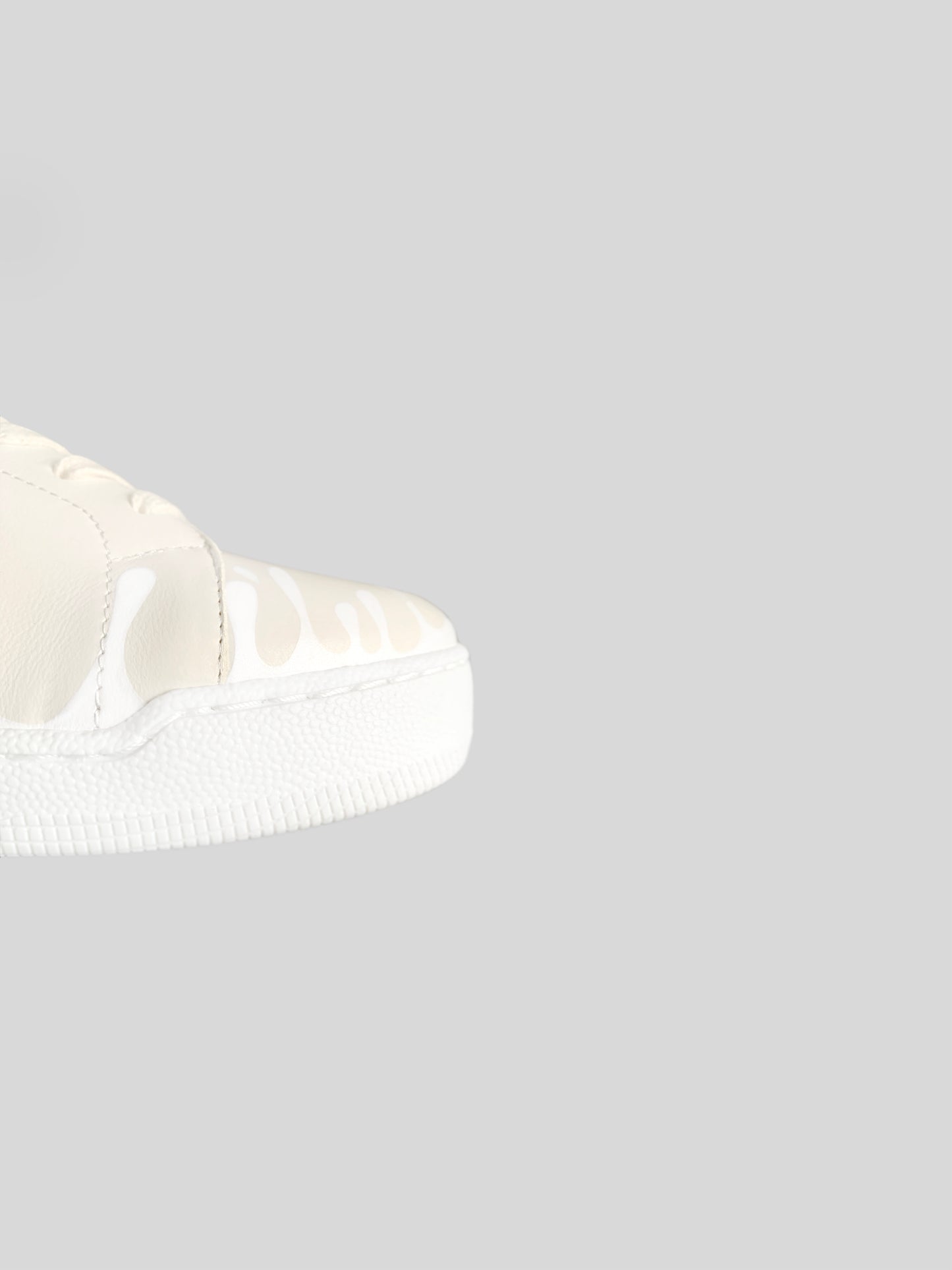 Front focus of cream Chrome-free Nappa leather mid-top sneakers with exclusive printed white drops design and white soles