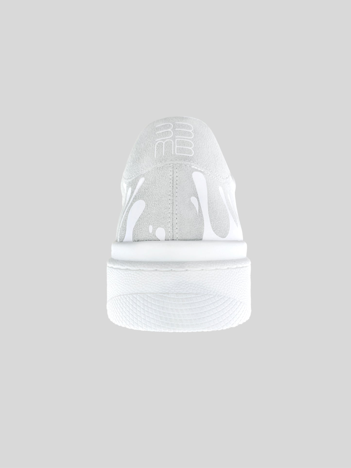 Back view of white suede low-top sneakers with exclusive printed white drops design and white sole