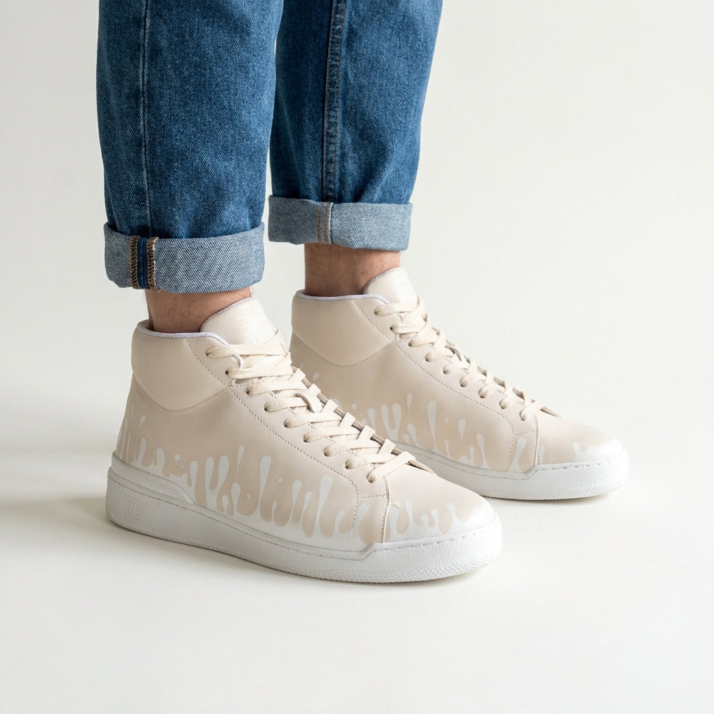 Lifestyle shot of 33MB Dawn sneakers paired with jeans, showcasing the urban mid-top silhouette with the  Zero Gravity® signature motif of upward drops representing hope.