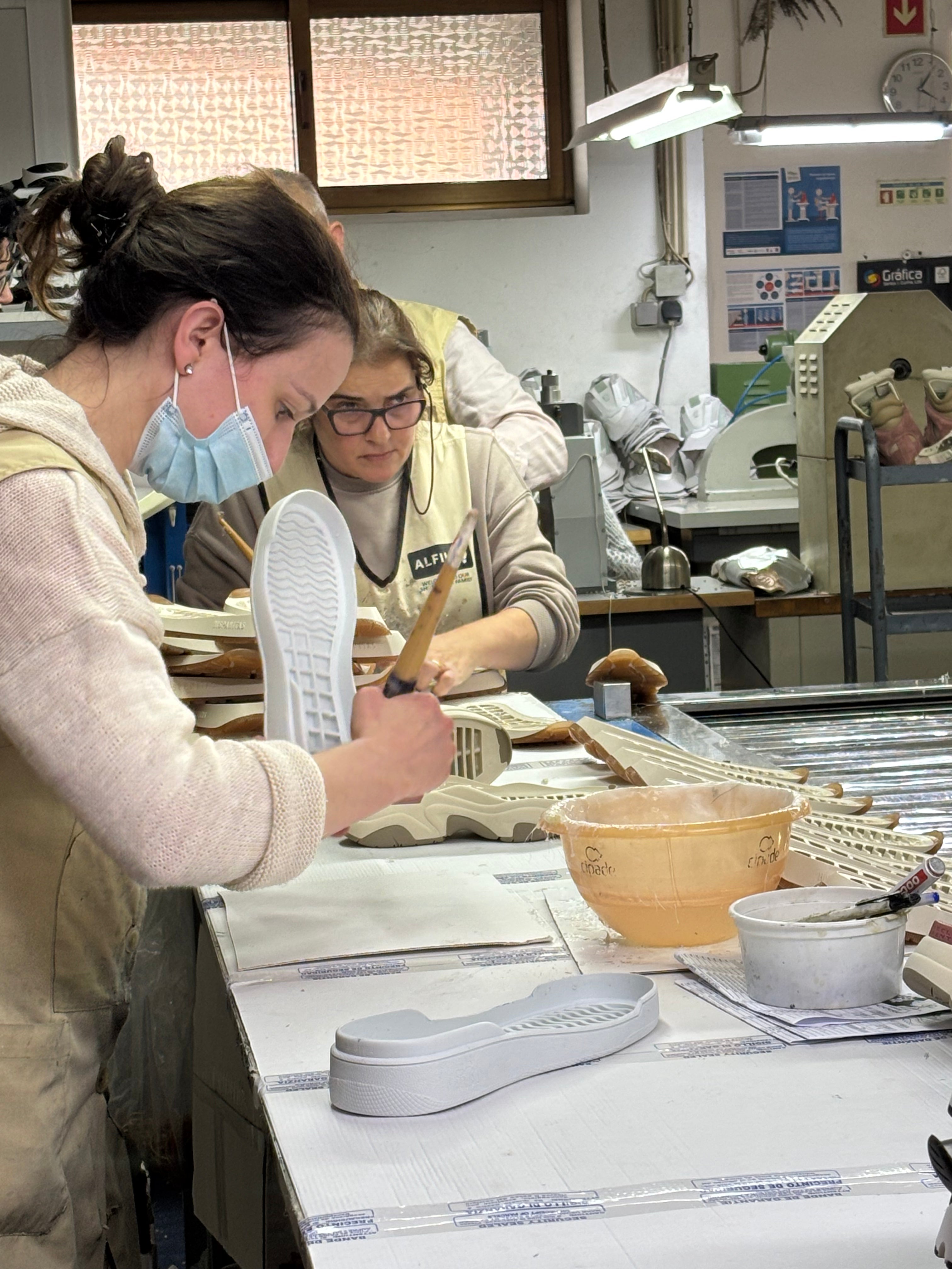 Artisan applying glue to our 33MB premium leather sneaker sole