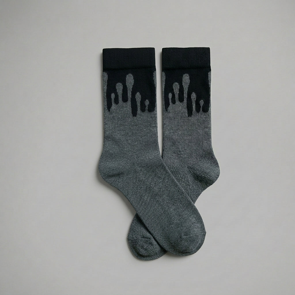 Pair of premium 33MB organic cotton crew socks in dark grey and black featuring the signature Zero Gravity design of paint droplets flowing upward, symbolizing hope and constant positivity