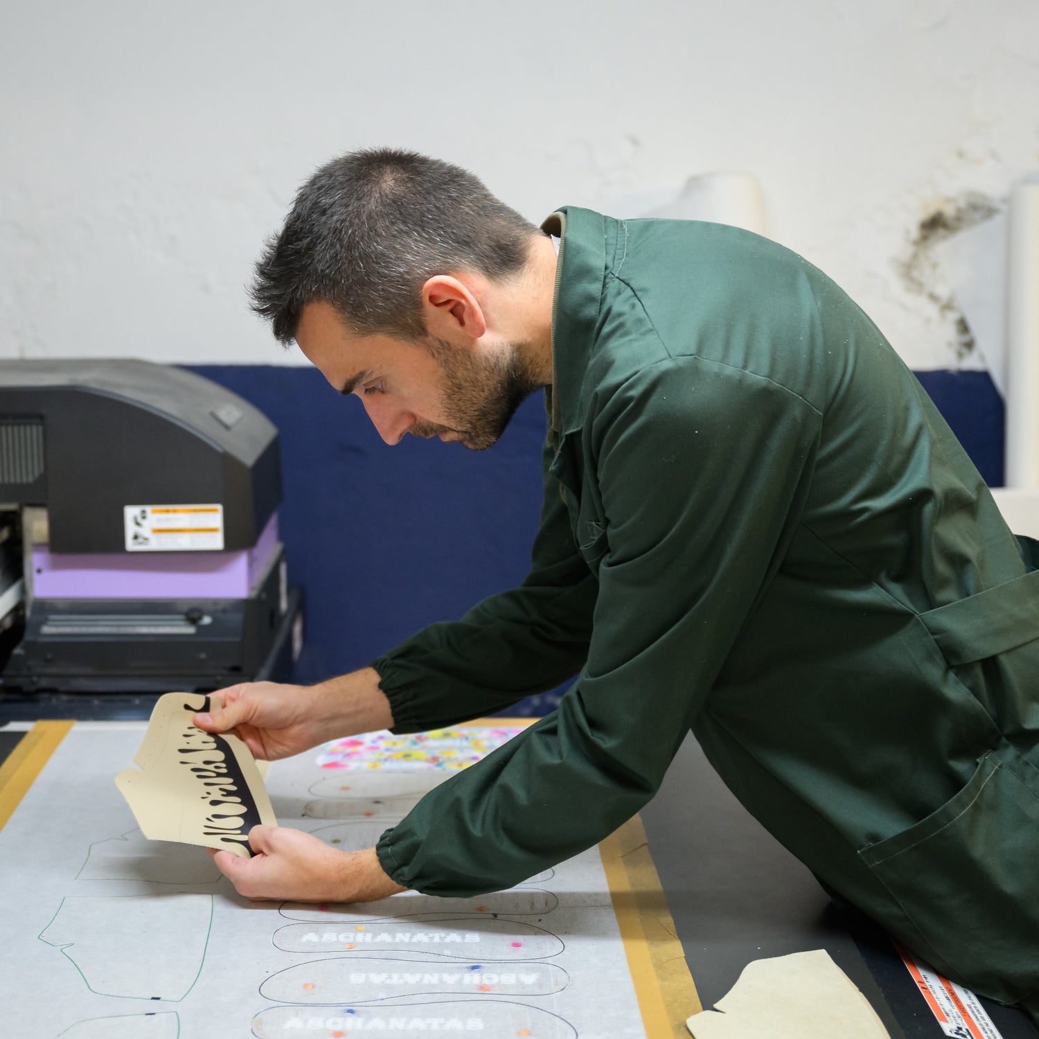 Our expert printer checking the design quality of our 33MB premium leather sneaker