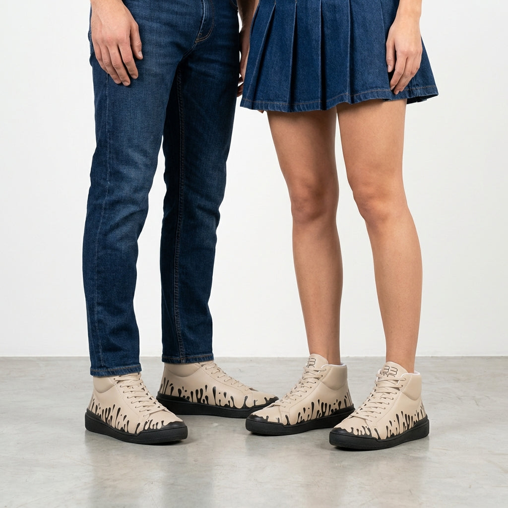 33MB Coco-Ah mid-top sneakers styled with dark jeans and dark denim skirt, highlighting the  Zero Gravity® signature motif of upward drops symbolizing hope.