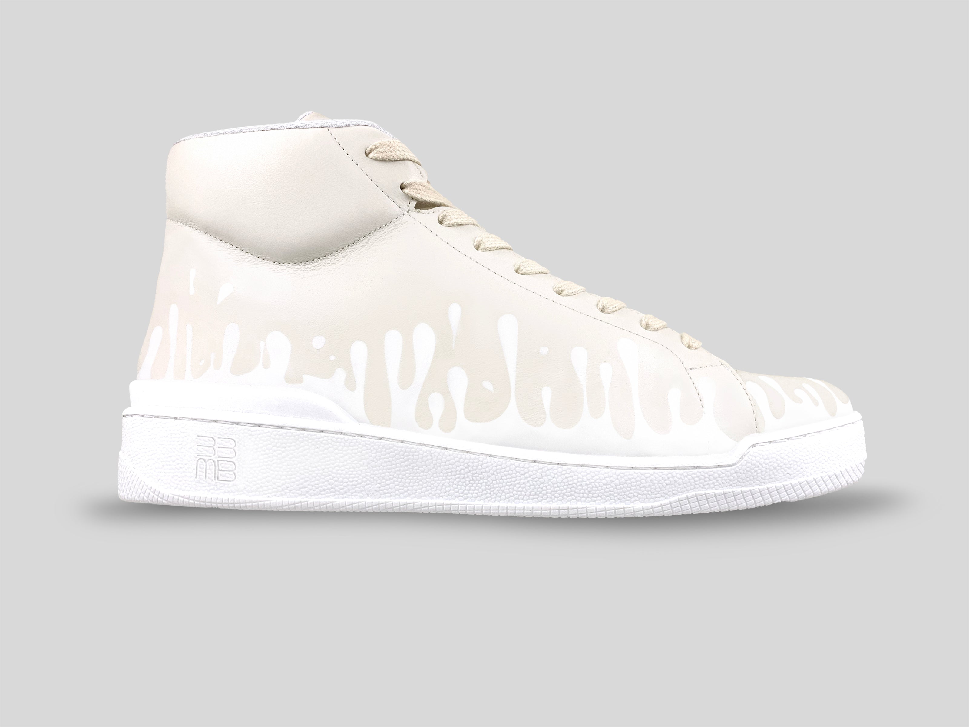 Side view of 33MB Dawn Mid-Top sneakers in cream Italian leather with signature white Zero Gravity drops traveling upward from the sole.