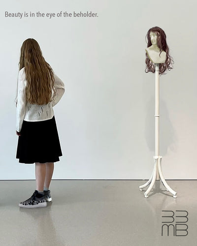 Person wearing black leather sneakers with drop design standing next to a mannequin with a wig