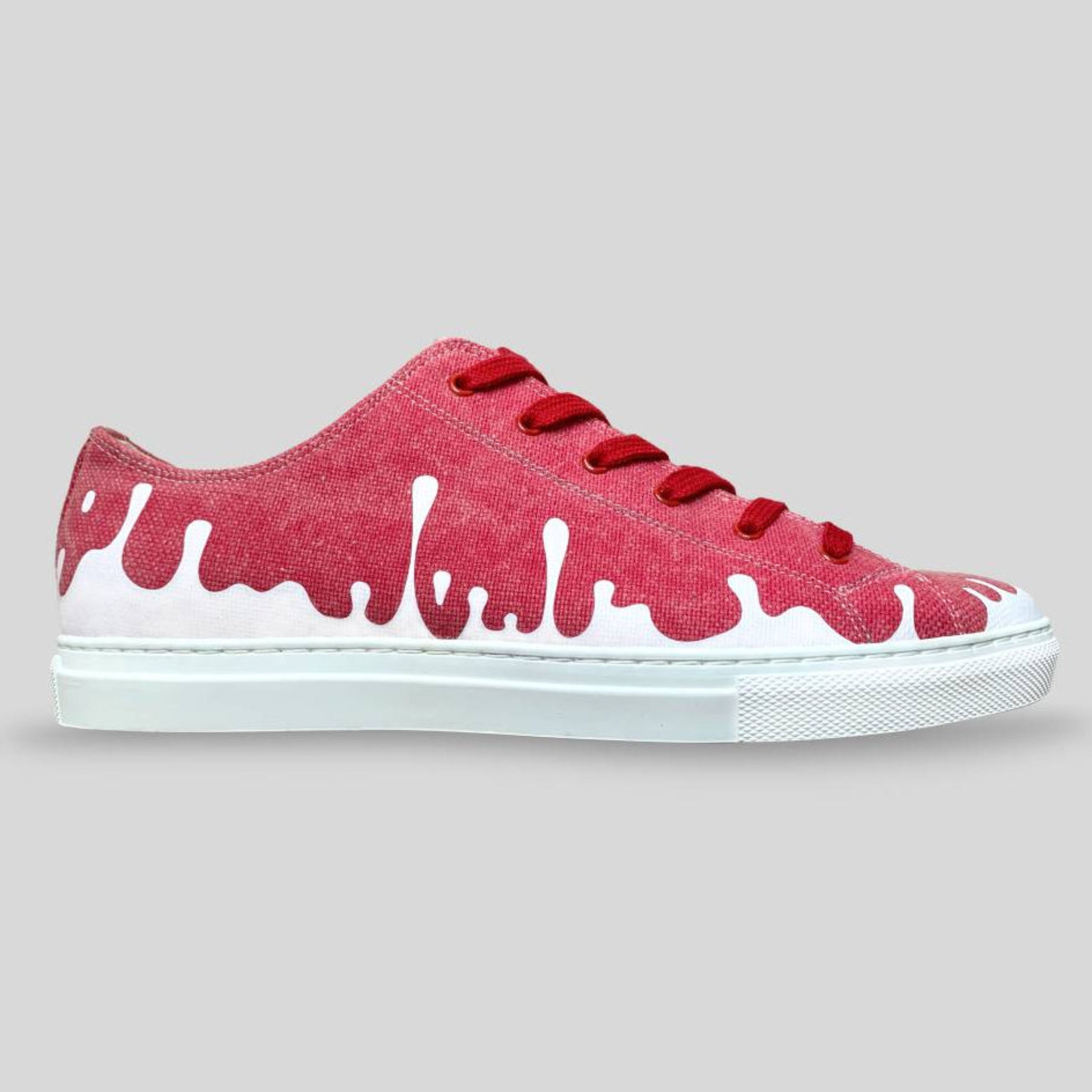 Right Side view of recycled raspberry red canvas 33MB low-top Sunset sneakers featuring the Zero Gravity® upward-drop motif on a gray background