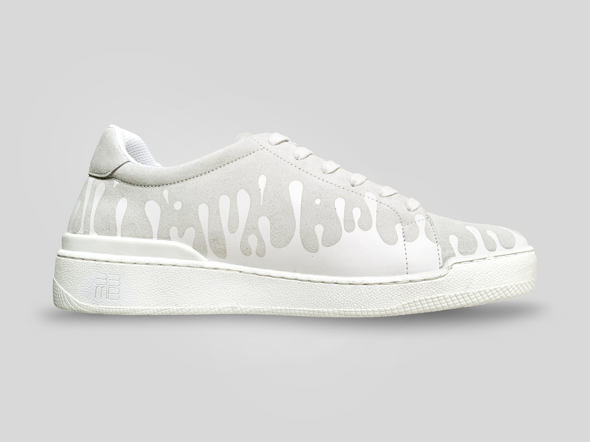 White suede low-top sneaker with 
exclusive printed white drops design and white sole