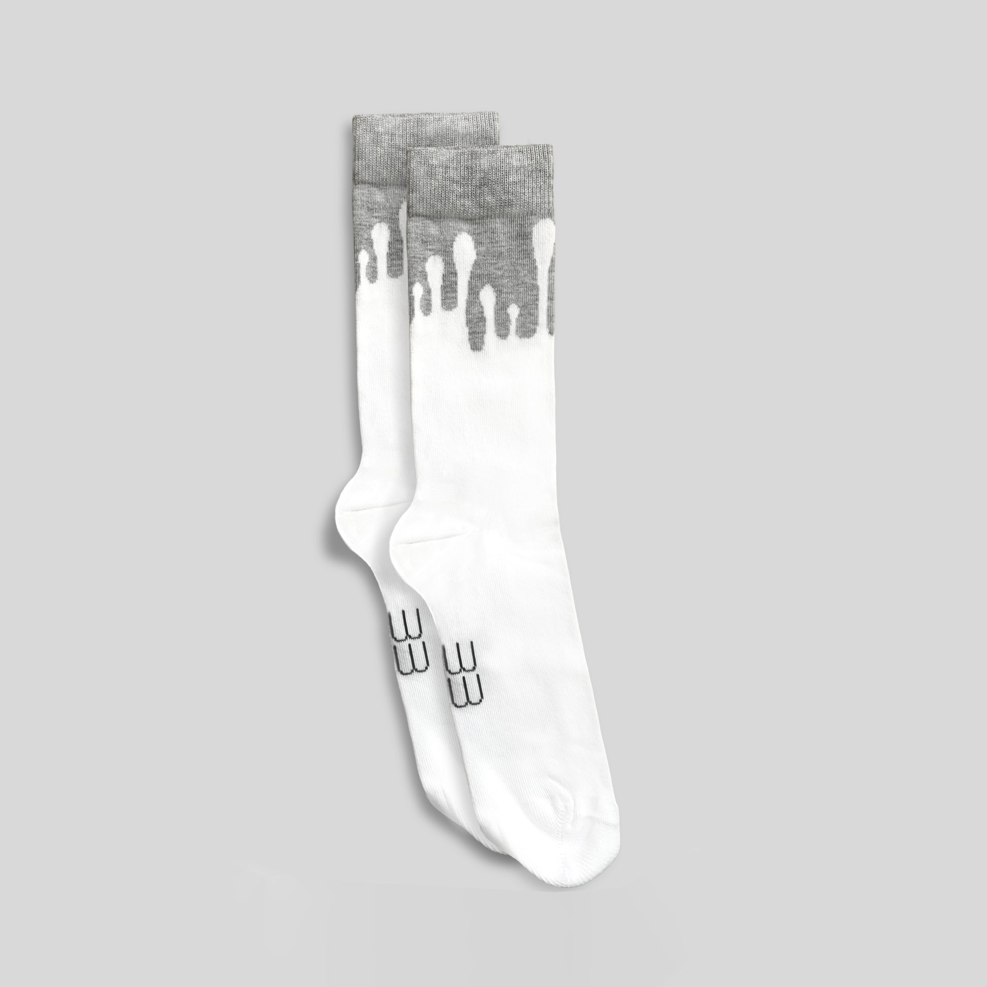 Pair of premium 33MB organic cotton crew socks in white and light grey, featuring the signature Zero Gravity design of white paint droplets flowing upward, symbolizing hope and constant positivity