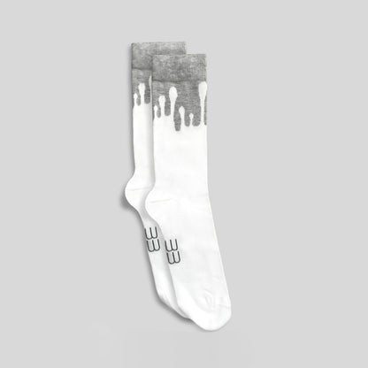 Pair of premium 33MB organic cotton crew socks in white and light grey, featuring the signature Zero Gravity design of white paint droplets flowing upward, symbolizing hope and constant positivity