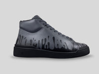 Side profile of 33MB Nighty mid-top sneakers in dark grey leather, showcasing the black Zero Gravity paint drops traveling upward from the sole.