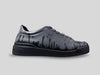 Side view of 33MB Nighty low-top sneakers in dark grey full-grain leather, featuring black Zero Gravity® paint drops defying gravity by moving upward.