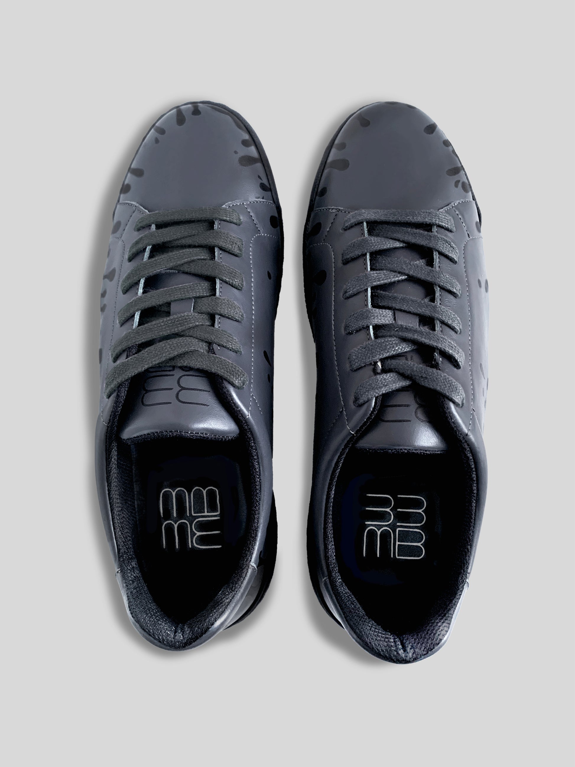 Top view of pair of dark grey Chrome-free Nappa leather low-top sneakers with exclusive printed black drops design