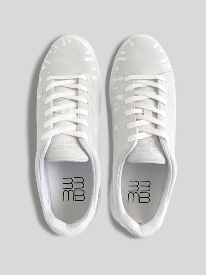 Top view of pair of white suede low-top sneakers with exclusive printed white drops design