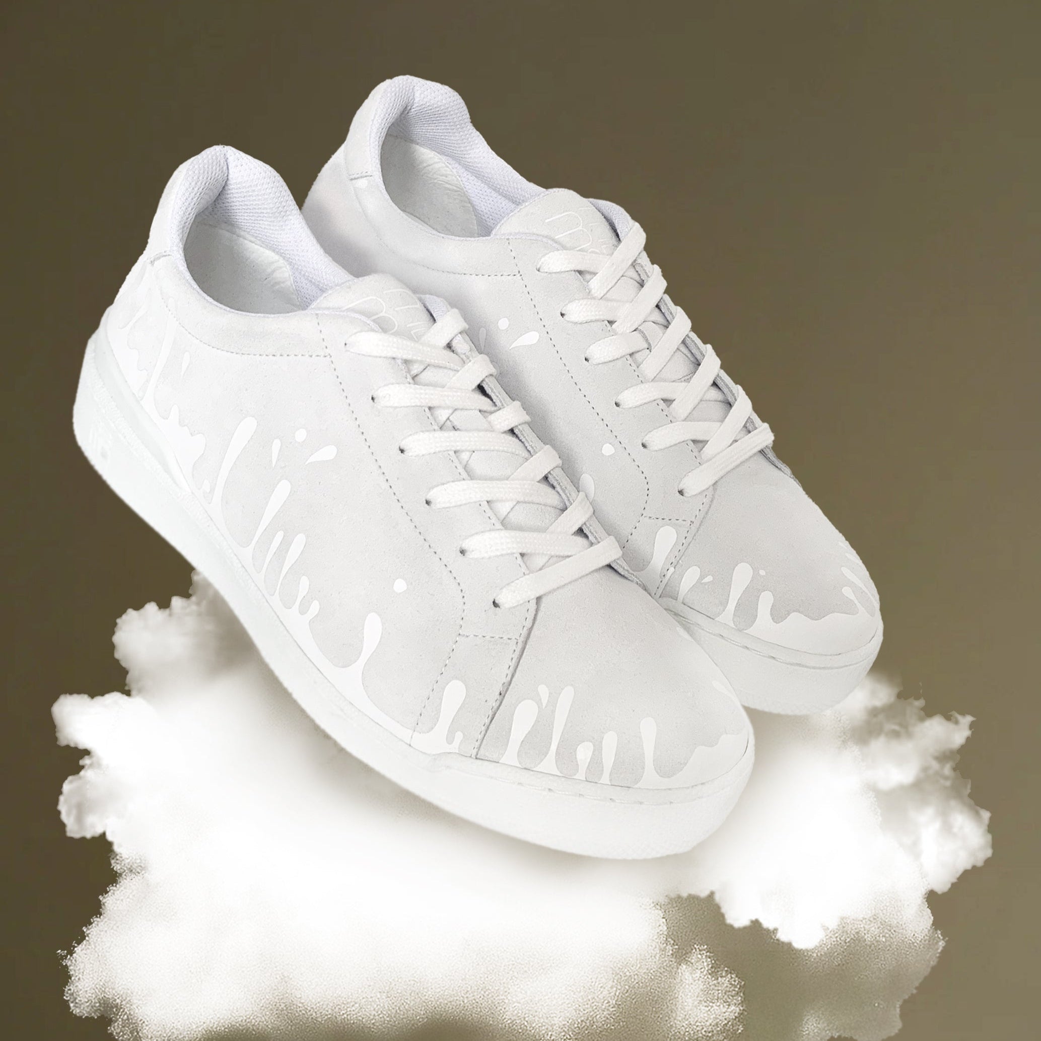 White leather sneakers on a reflective surface with a neutral background