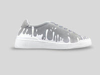 Side profile of 33MB Splash low-top sneakers in dark grey suede, featuring white Zero Gravity®  paint drops traveling upward from the sole.