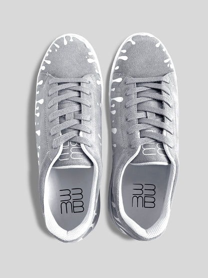 Top view of pair of grey suede low-top sneakers with exclusive printed white drops design