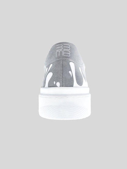 Back view of grey suede low-top sneaker with exclusive printed white drops design and white sole
