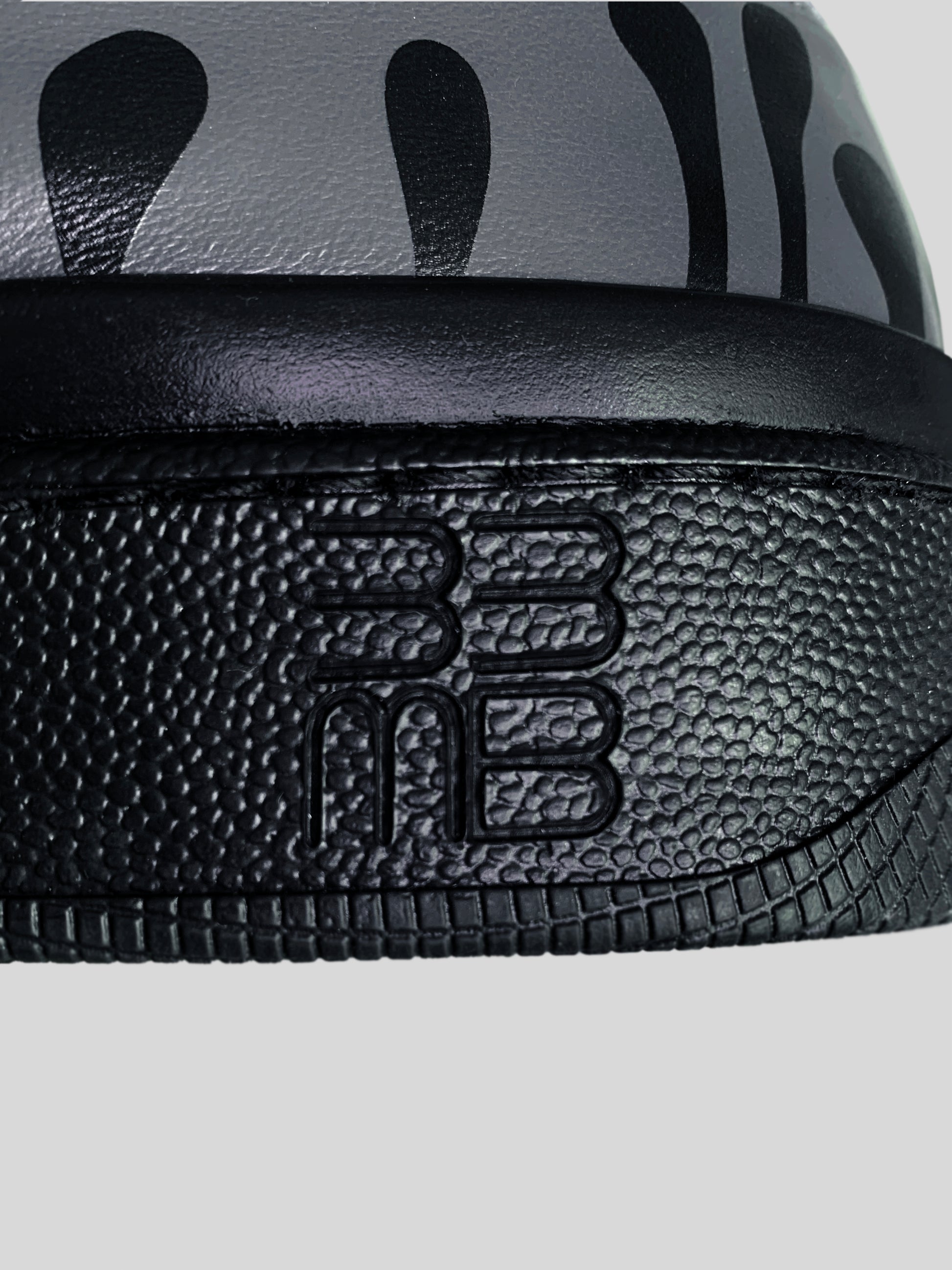 Focus on black sole with logo of  dark grey Chrome-free Nappa leather low-top sneaker with exclusive printed black drops design