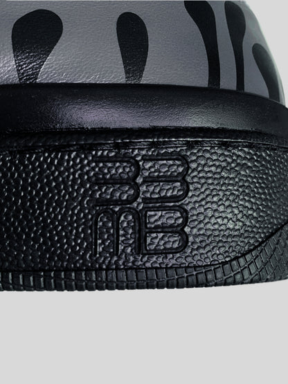 Focus on black sole with logo of  dark grey Chrome-free Nappa leather low-top sneaker with exclusive printed black drops design