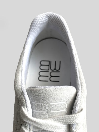 Focus on mesh lining in white suede low-top sneakers