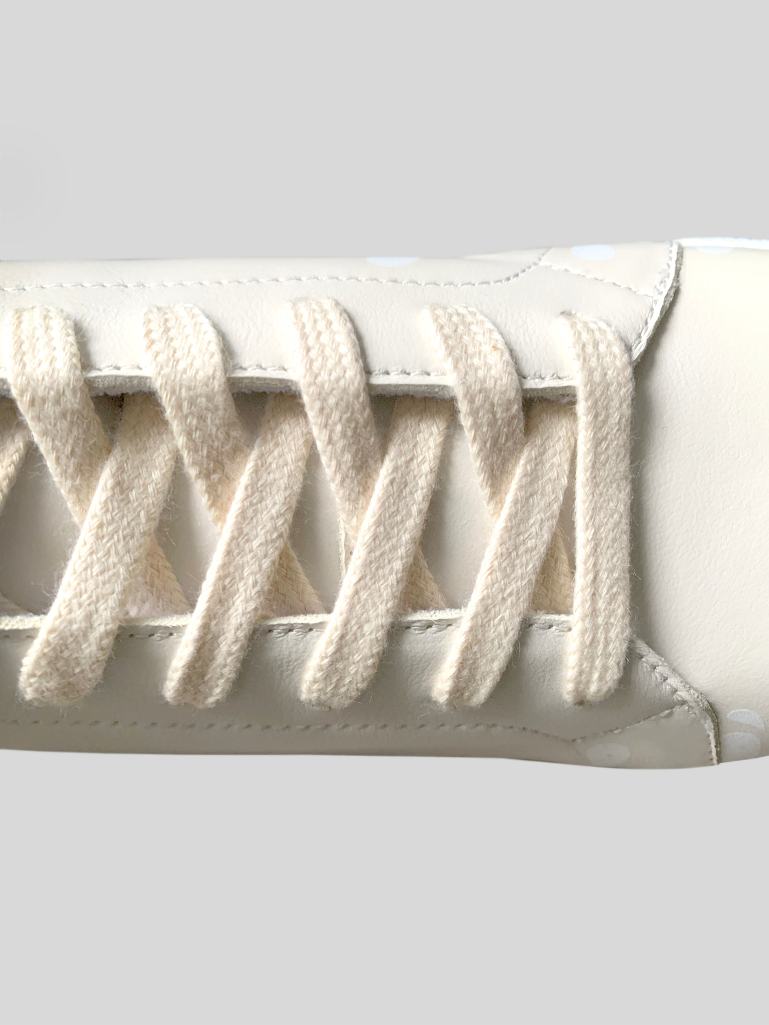 Focus on cream color laces on cream Chrome-Free Nappa leather sneakers