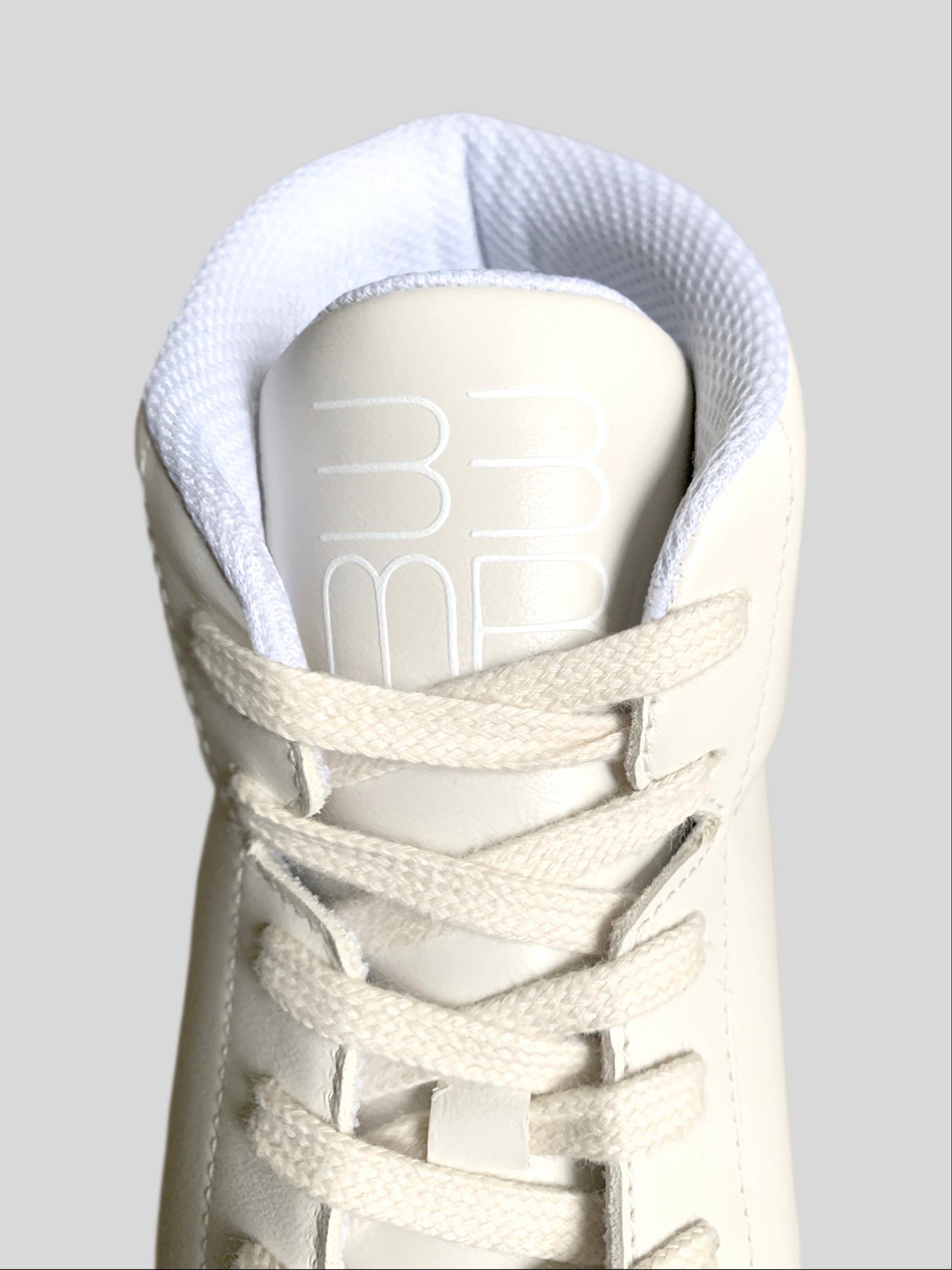 Focus on mesh lining and cream laces on cream Chrome-free Nappa leather mid-top sneakers 