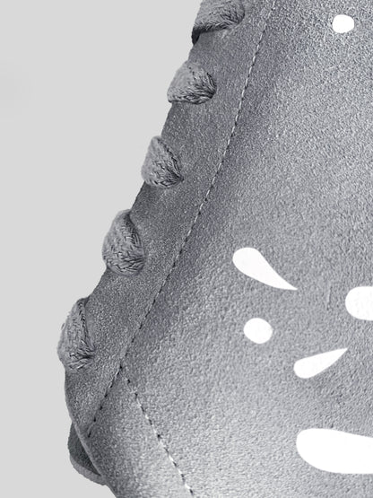 Side focus of grey suede low-top sneaker with exclusive printed white drops design and white sole